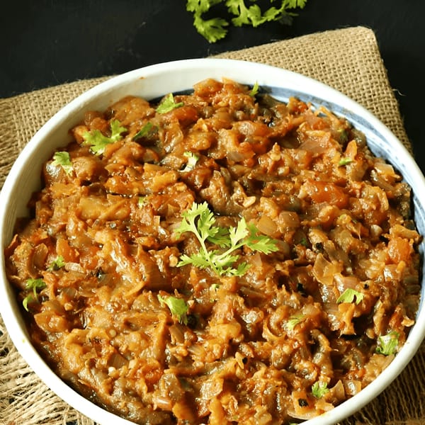 A bowl of Tandoor Fine Indian Cuisine's Indian eggplant bharta, garnished with fresh cilantro.